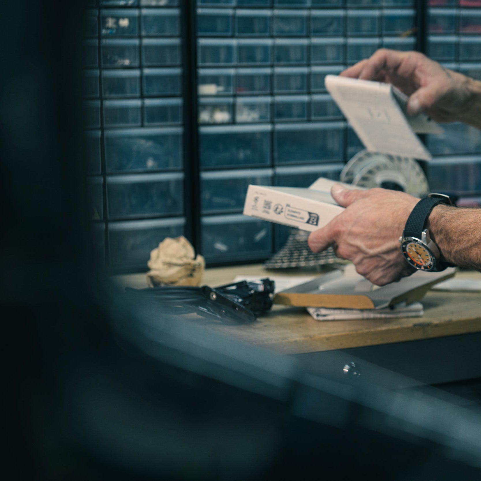 Person holding bike components in Cadence Cyclery Encinitas bike service center.