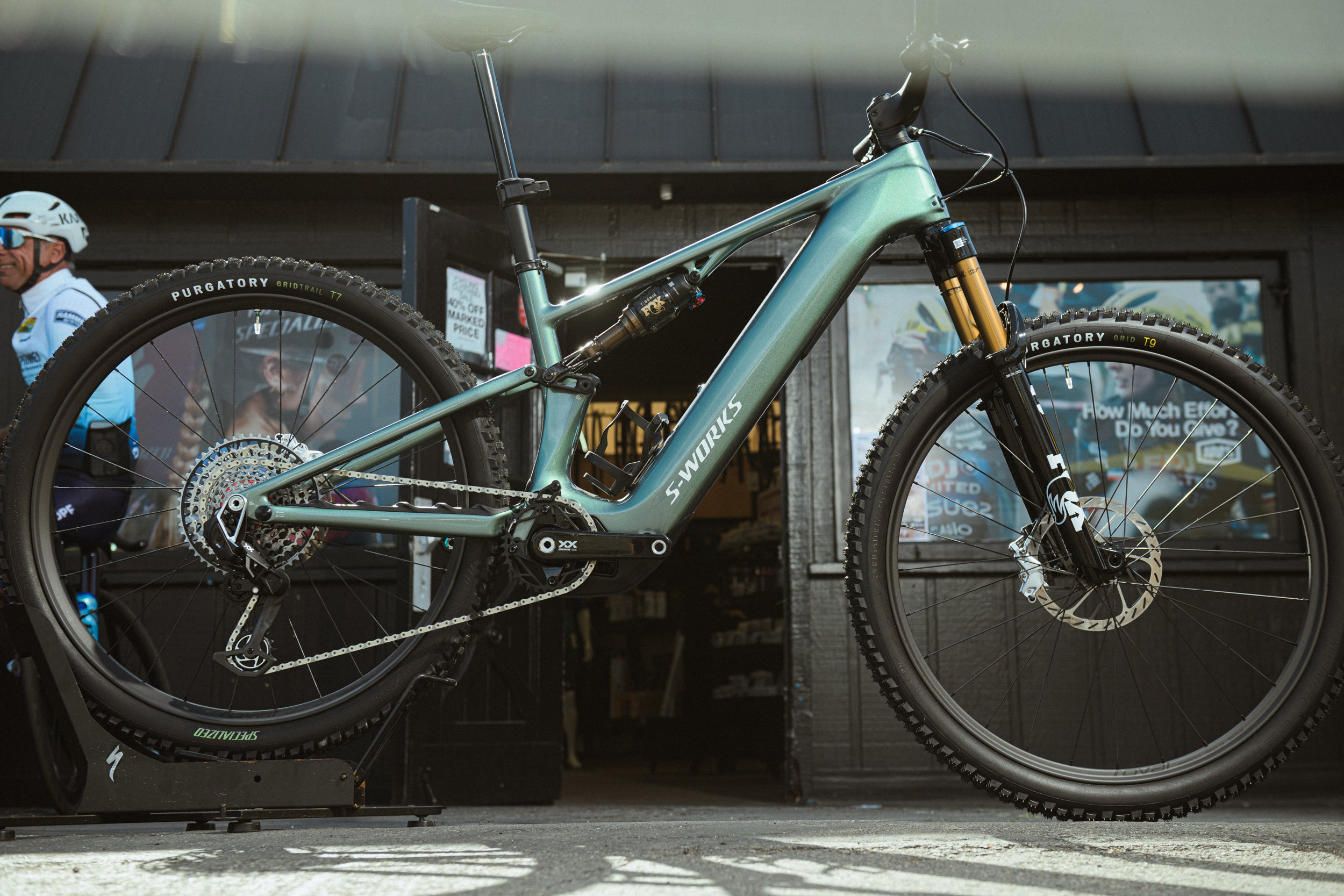 New Specialized LEVO E-mountain bike on display in a store with a person in the background.